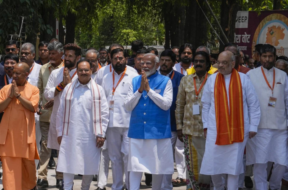 Indian Prime Minister Narendra Modi, in blue, accompanied by leaders of the National Democratic Alliance (NDA) that includes the Bharatiya Janata Party (BJP), returns after filing his nomination papers to contest as a candidate for the parliamentary elections in Varanasi, Uttar Pradesh state, India, Tuesday, May 14, 2024. (AP Photo)