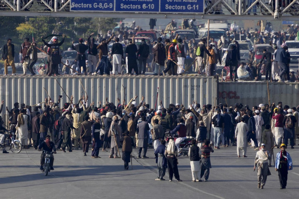 Supporters of imprisoned former premier Imran Khan’s Pakistan Tehreek-e-Insaf party, gather to remove shipping containers to clear way for their rally demanding Khan’s release, in Islamabad, Pakistan, Tuesday, Nov. 26, 2024. (AP Photo)