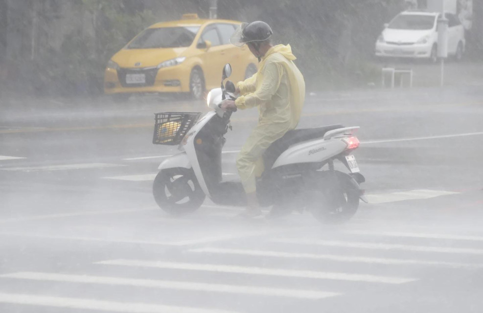 A man struggles in the heavy wind and rain generated by Typhoon Krathon in Kaohsiung, southern Taiwan, Thursday, Oct. 3, 2024. (AP Photo)