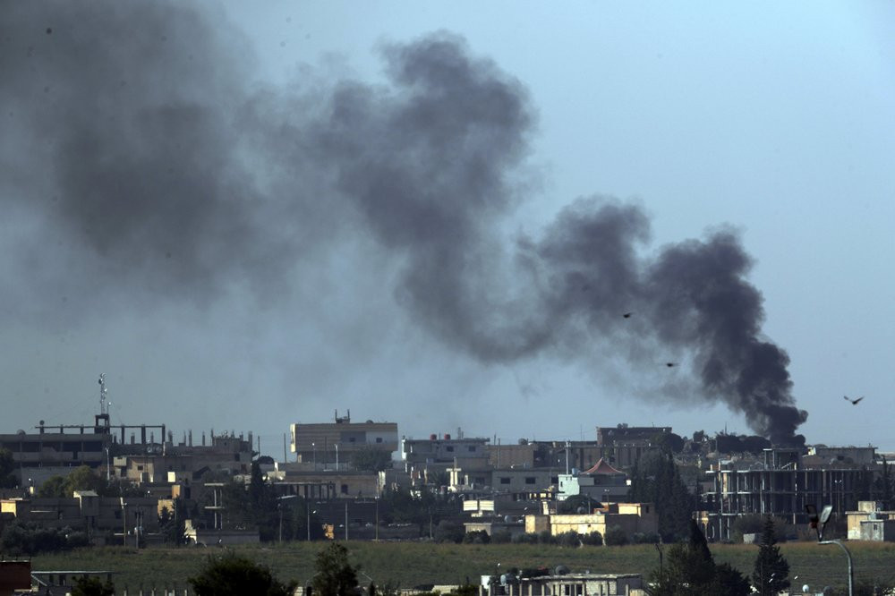 In this photo taken from the Turkish side of the border between Turkey and Syria, in Akcakale, Sanliurfa province, southeastern Turkey, smoke billows from targets in Tel Abyad, Syria, during 