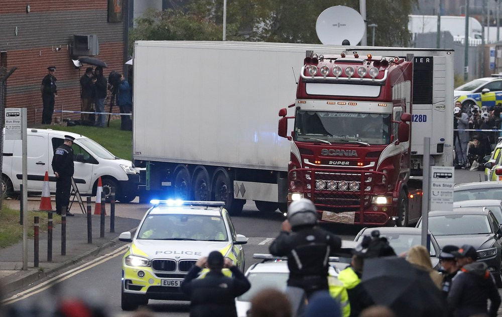 Police escort the truck, that was found to contain a large number of dead bodies, as they move it from an industrial estate in Thurrock, south England, Wednesday Oct. 23, 2019.