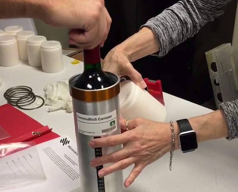 In this Saturday, Nov. 2, 2019 photo provided by Space Cargo Unlimited, researchers with Space Cargo Unlimited prepare bottles of French red wine to be flown aboard a Northrop Grumman capsule