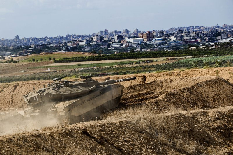 In this Oct. 27, 2018, file photo, Israeli tank takes a position at the Gaza Strip border. The Israeli military on Wednesday said it has carried out a “wide-scale” strike on Iranian targets i