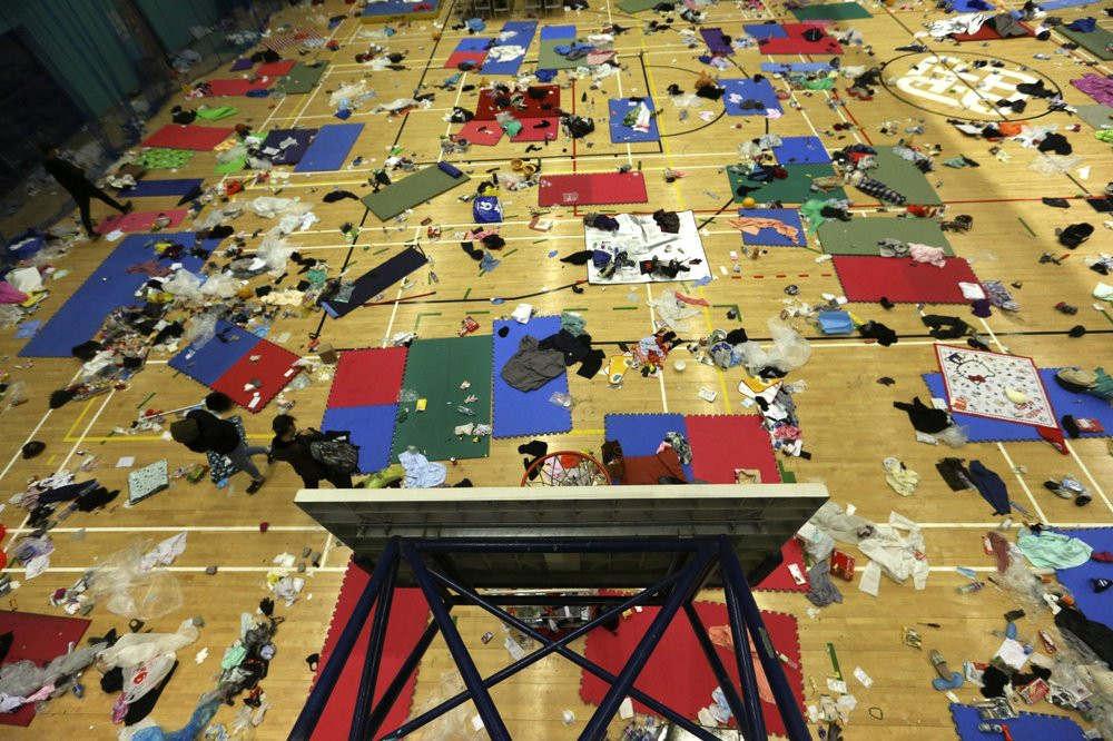 Protesters walk in a gymnasium on the campus of the Polytechnic University in Hong Kong, Wednesday, Nov. 20, 2019.