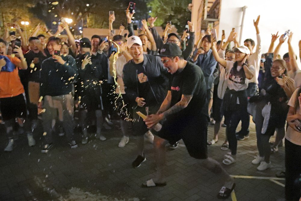 Pro-democracy supporters celebrate after pro-Beijing politician Junius Ho lost his election in Hong Kong, early Monday, Nov. 25, 2019.