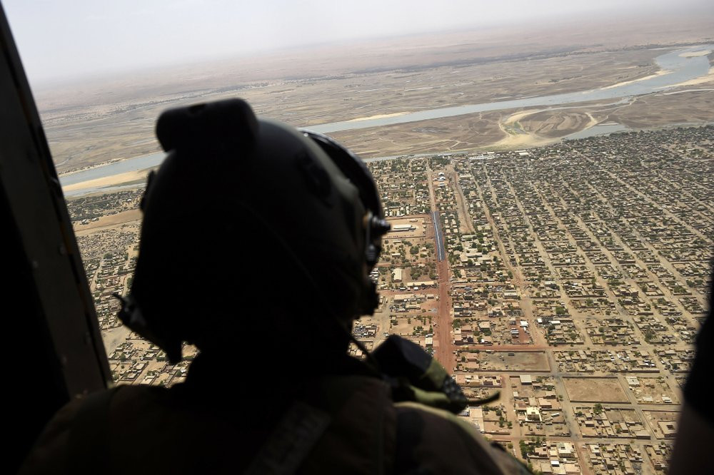 In this May 19, 2017 file photo, a French soldier stands inside a military helicopter during a visit by French President Emmanuel Macron to the troops of Operation Barkhane, France's largest 