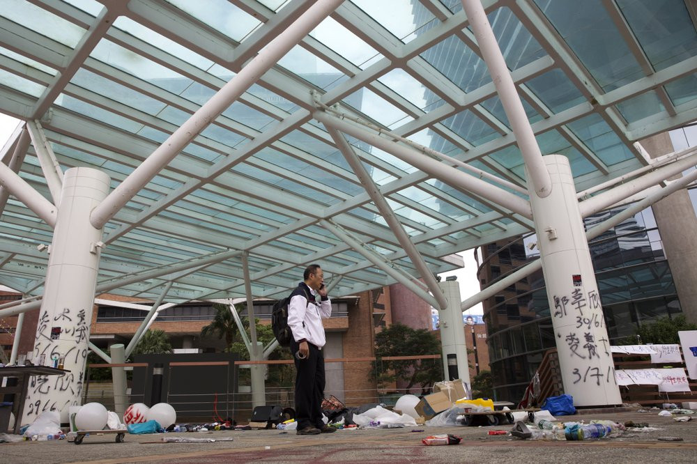 Professor Alex Wai, Vice President of the Polytechnic University, takes in the vandalized campus as he leads a team of school officials and first aid providers.