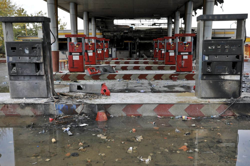 In this Nov. 20, 2019, file photo, rainwater pools at a gas station attacked during protests over government-set gasoline prices in Tehran, Iran.
