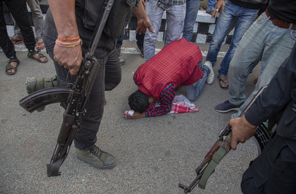 A demonstrator begs a police officer to allow them to proceed ahead during a protest against the Citizenship Amendment Bill (CAB) in Gauhati, India, Wednesday, Dec. 11, 2019.