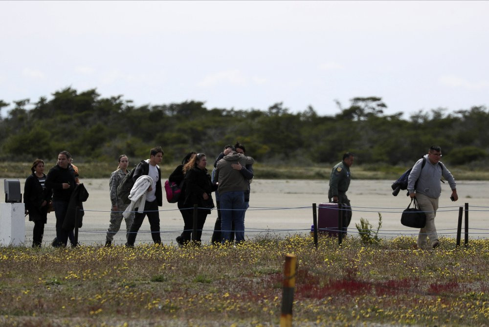 Relatives of passengers of a missing military plane arrive to an airbase in Punta Arenas, Chile, Wednesday, Dec. 11, 2019.