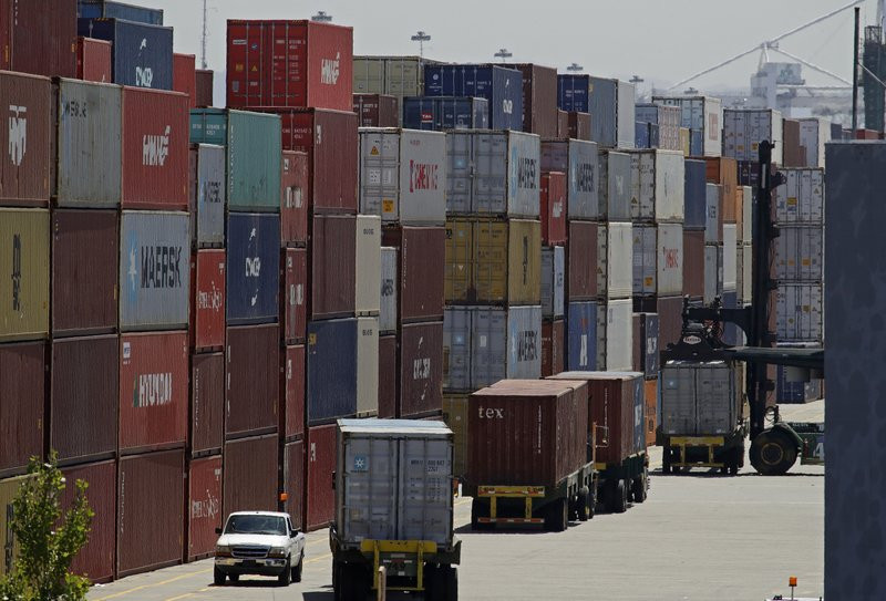 In this July 22, 2019, file stacked containers wait to be loaded on to trucks at the Port of Oakland in Oakland, California.