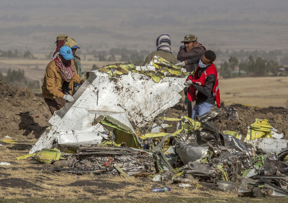 In this file photo dated Monday, March 11, 2019, rescuers work at the scene of an Ethiopian Airlines plane crash south of Addis Ababa, Ethiopia.