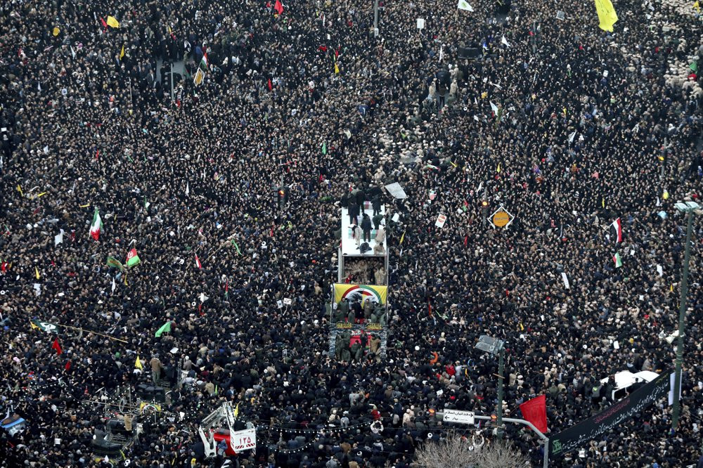 Coffins of Gen. Qassem Soleimani and others who were killed in Iraq by a U.S. drone strike, are carried on a truck surrounded by mourners during a funeral procession, in the city of Mashhad, 