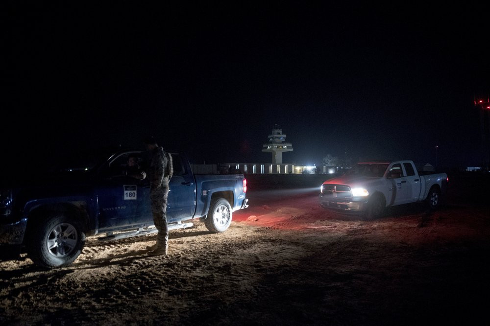 In this Dec. 26, 2018, file photo, members of the military wait outside facilities where President Donald Trump and first lady Melania Trump are visiting at Ain al-Asad air base, Iraq.