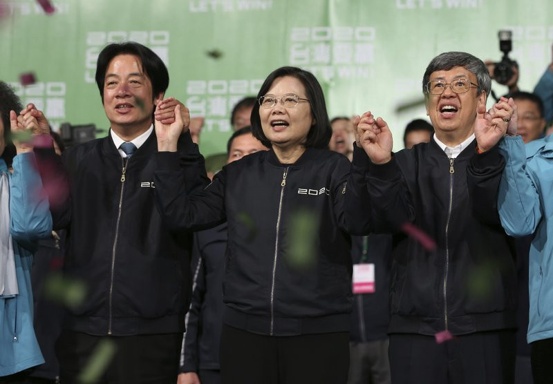 Taiwan's 2020 presidential election candidate, Taiwanese President Tsai Ing-wen, center, anf her running mate William Lai, left, celebrate their victory with supporters in Taipei, Taiwan, Sat