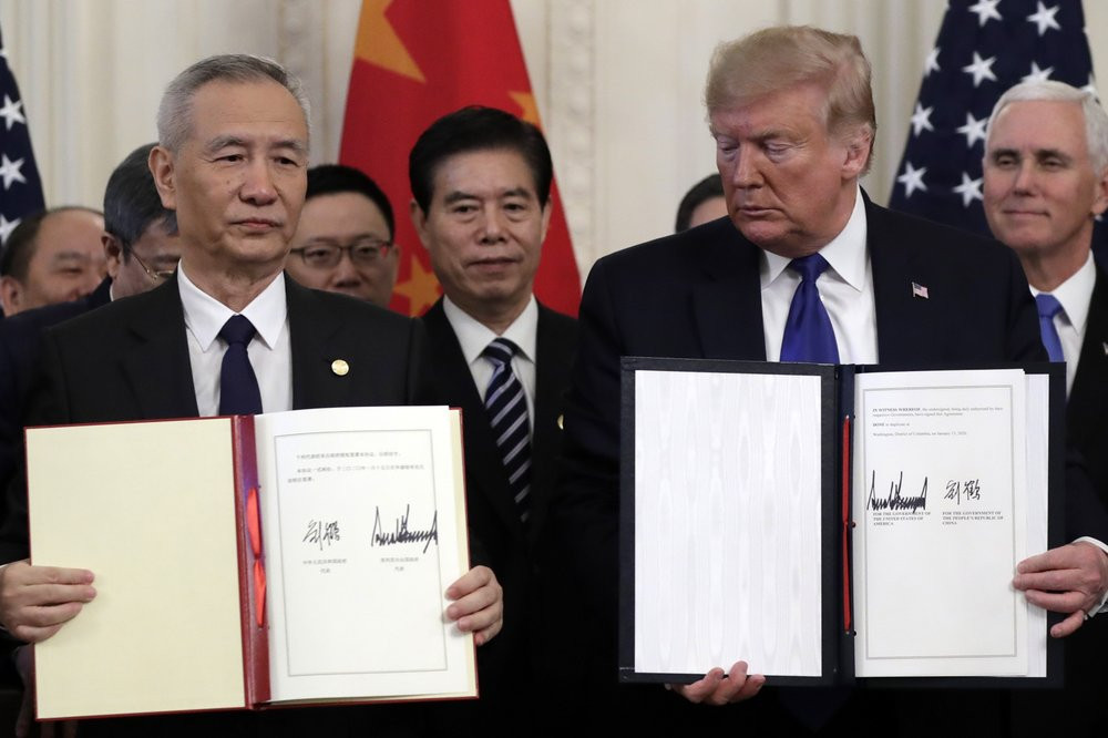 President Donald Trump holds the signed a trade agreement with Chinese Vice Premier Liu He, in the East Room of the White House, Wednesday, Jan. 15, 2020, in Washington.