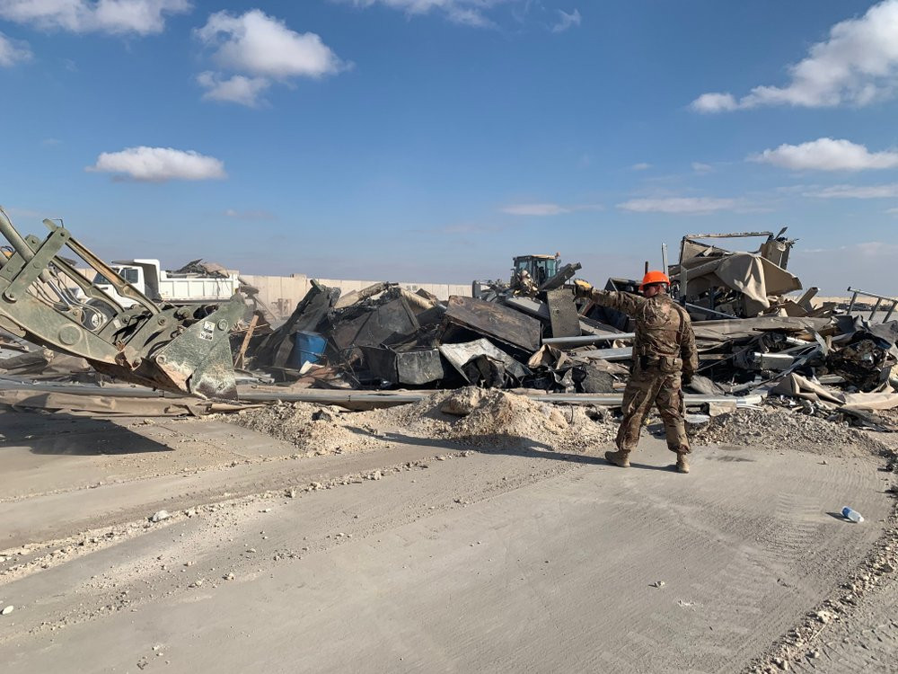 U.S. soldiers clear rubble from a site of Iranian bombing at Ain al-Asad air base in Anbar, Iraq, Monday, Jan. 13, 2020.