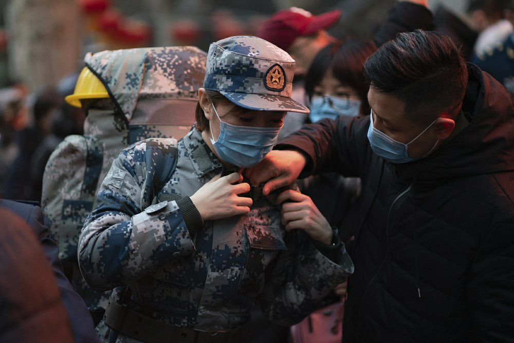 In this photo taken Jan 24, 2020 and released by Xinhua News Agency, a military medic from the Air Force Medical University prepares to leave for Wuhan from Xi'an, capital of northwestern Chi