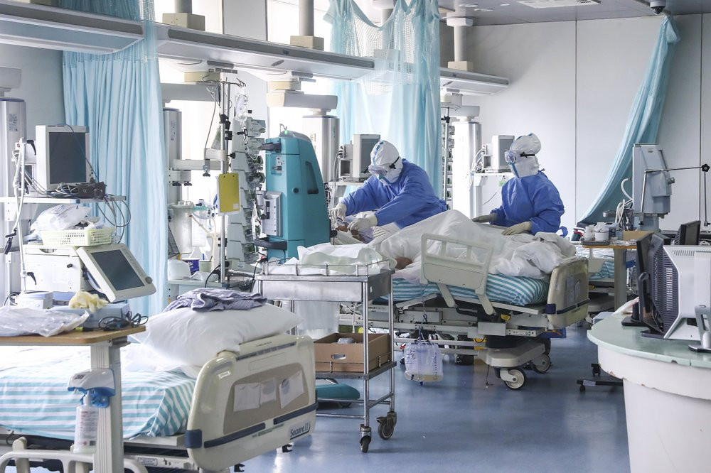 In this Feb. 13, 2020 photo released by China's Xinhua News Agency, nurses in protective suits treat a patient in the intensive care unit at Ditan Hospital in Beijing, one of the hospitals in