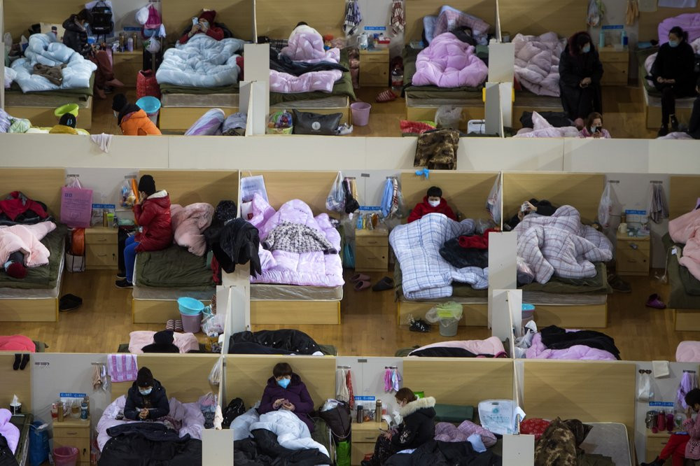 In this Monday, Feb. 17, 2020, photo released by Xinhua News Agency, patients infected with the coronavirus take rest at a temporary hospital converted from Wuhan Sports Center in Wuhan in ce