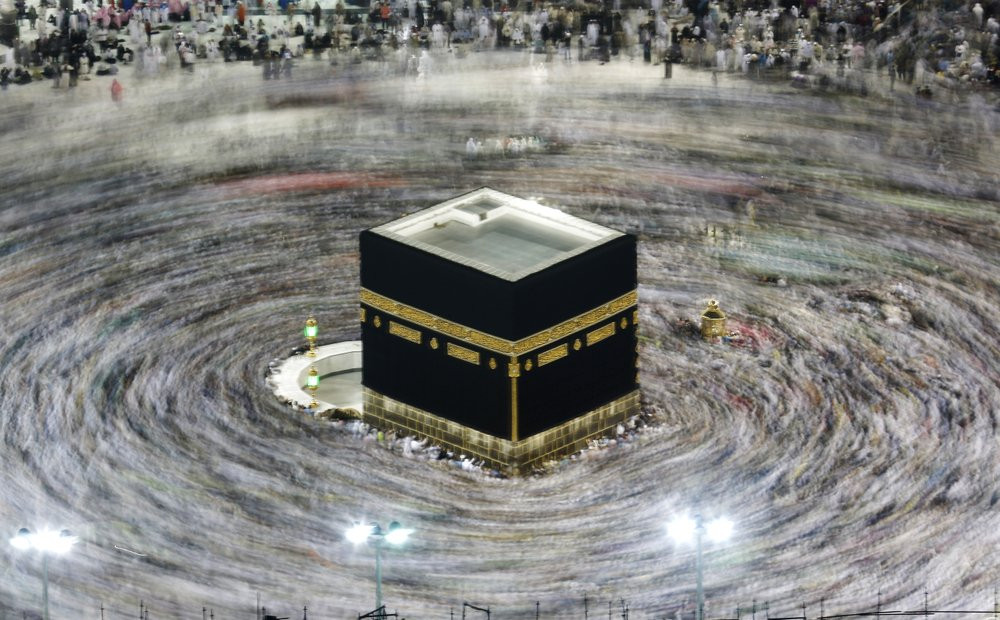 In this Aug. 13, 2019, file photo taken with a slow shutter speed, Muslim pilgrims circumambulate the Kaaba, the cubic building at the Grand Mosque, during the hajj pilgrimage in the Muslim h