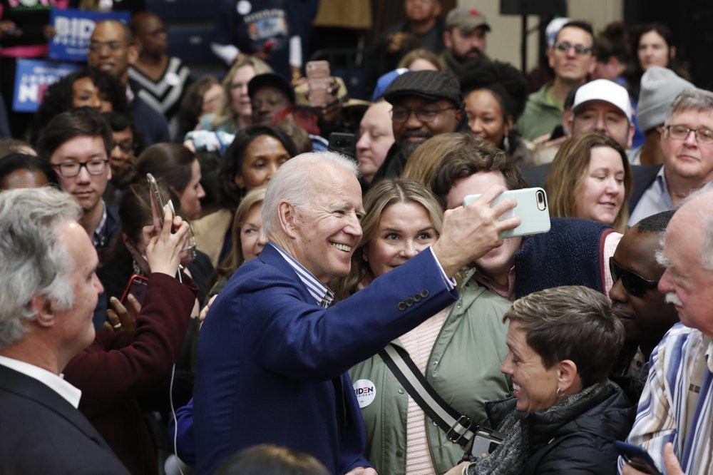Democratic presidential candidate former Vice President Joe Biden takes photos with supporters at a campaign event at Saint Augustine's University in Raleigh, N.C., Saturday, Feb. 29, 2020.
