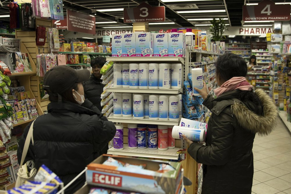 Customers look at sanitizing wipes on the shelves of a pharmacy in New York on Wednesday, March 4, 2020.