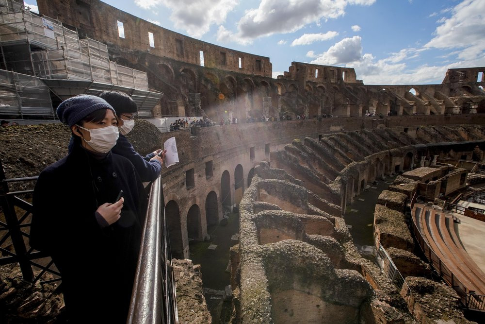 Tourists visit the Colosseum, in Rome, Saturday, March 7, 2020.