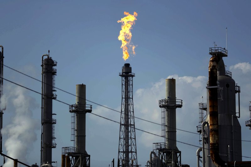 In this Thursday, Aug. 31, 2017, file photo, a flame burns at the Shell Deer Park oil refinery in Deer Park, Texas.