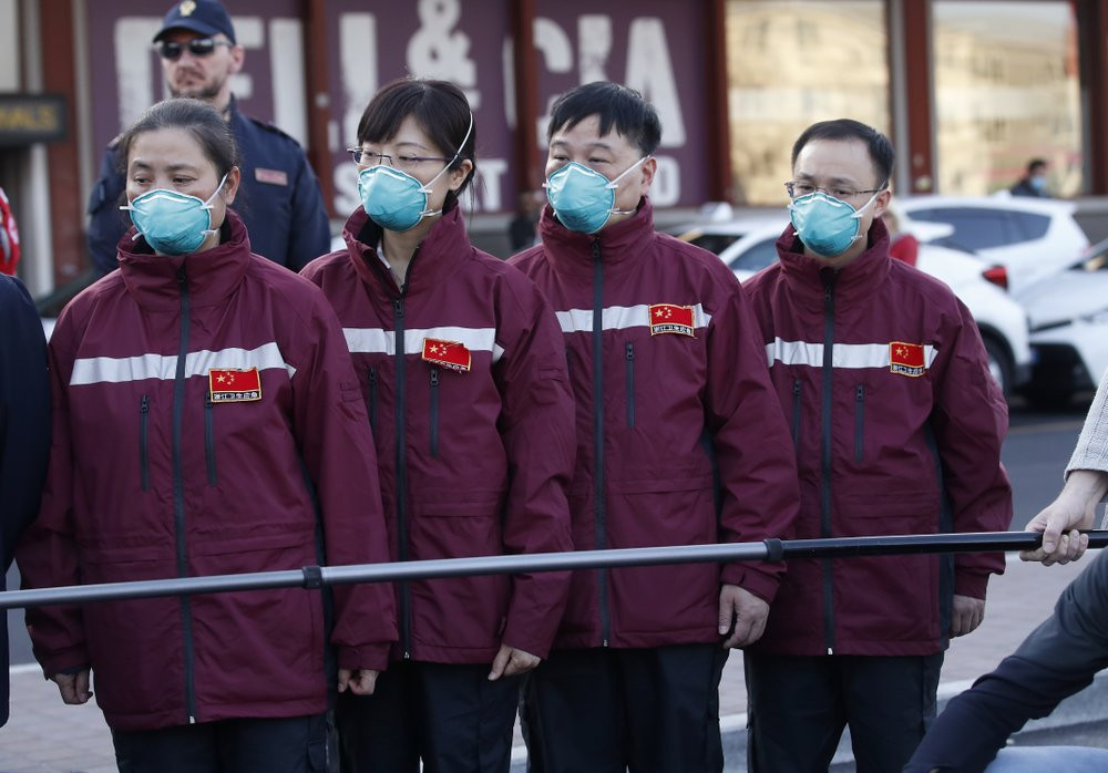 Medics and paramedics from China arrive at the Malpensa airport of Milan, Wednesday, March 18, 2020.