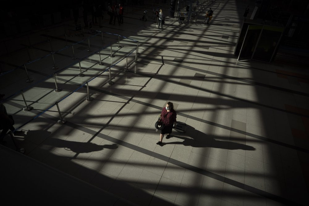 A passenger walks through an empty terminal at Ezeiza International Airport in Buenos Aires, Argentina, Monday, March 23, 2020. Most flights have been canceled to help stop the spread of the 