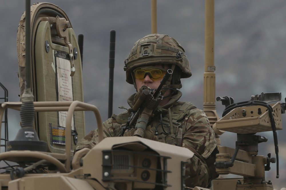 A British soldier with NATO-led Resolute Support Mission forces arrives at the site of an attack in Kabul, Afghanistan, Wednesday, March 25, 2020.