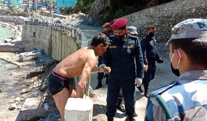 Darchula Police arresting a man who swam across the Mahakali river.