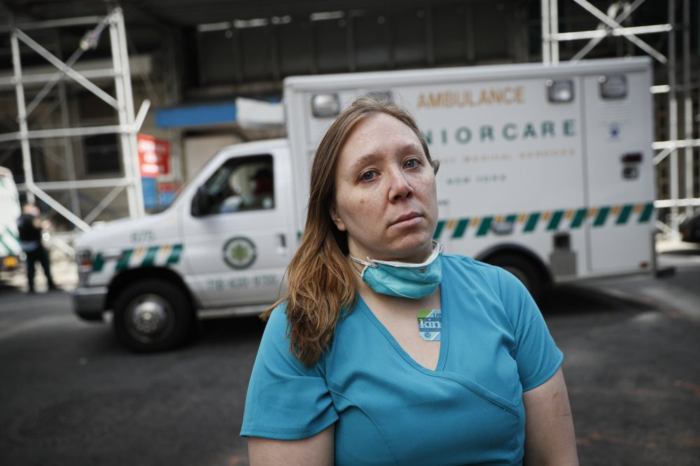Registered Nurse Elizabeth Schafer, 36, of South St. Paul, Minn., stands for a portrait before entering Beth Israel Mount Sinai Hospital for her second day volunteering to combat the COVID-19