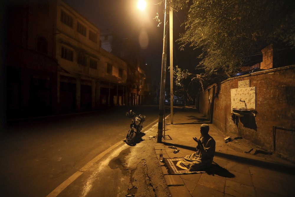 In this Saturday, April 25, 2020 file photo, a Muslim man prays on a street outside Jama Masjid on the first day of Ramadan during a nationwide lockdown to control the spread of coronavirus, 