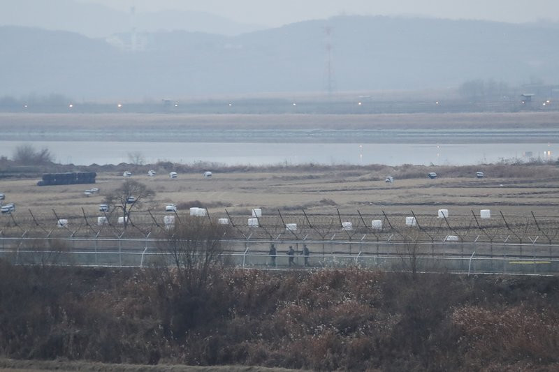 In this Dec. 16, 2019, file photo, South Korean army soldiers patrol along the barbed-wire fence in Paju, South Korea, near the border with North Korea.
