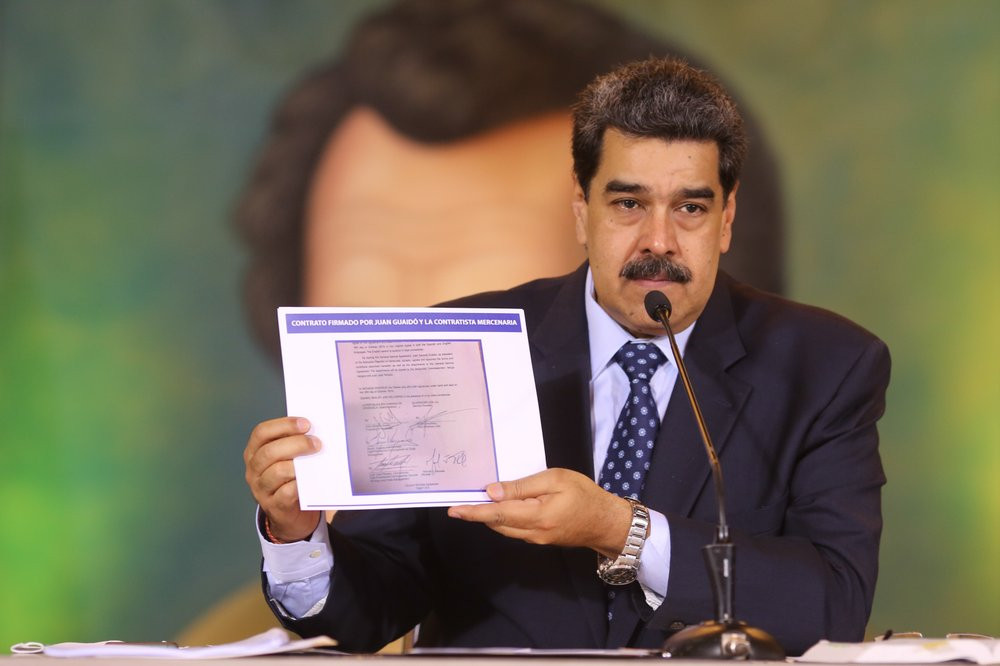 In this photo released by the Venezuela’s Miraflores presidential press office, President Nicolas Maduro accuses opposition leader Juan Guaido of being behind a military raid designed to oust