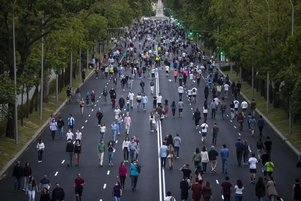 People exercise along Paseo de la Castellana after loosening of the lockdown measures imposed by the government due to coronavirus in Madrid, Spain, Saturday, May 9, 2020.