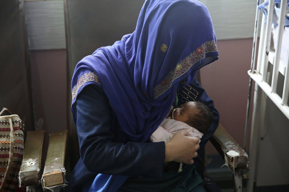 A mother breastfeeds her two-day-old baby at the Ataturk Children's Hospital a day after they were rescued from a deadly attack on another maternity hospital, in Kabul, Afghanistan, Wednesday