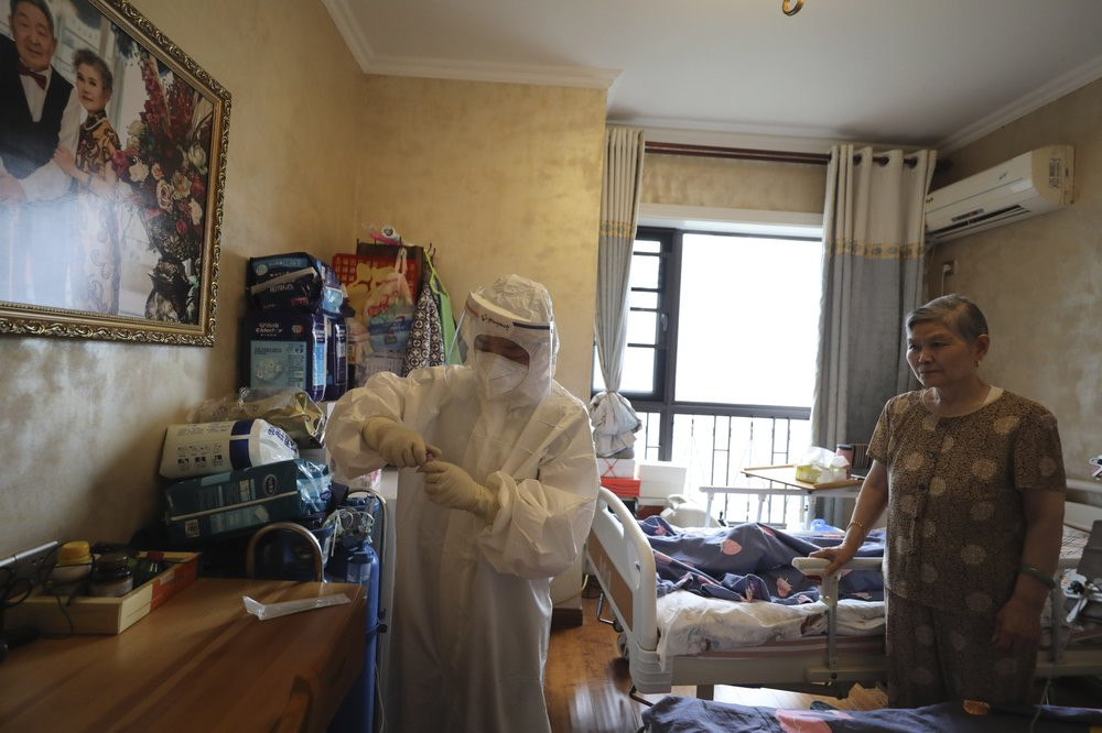 A medical worker collects swab samples from a resident for the coronavirus test during home visits in Wuhan the epicenter of China's coronavirus outbreak in central China's Hubei province, Th