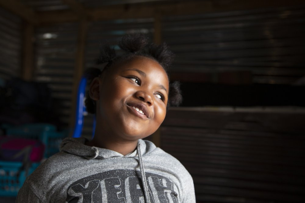 Lilitha Jiphethu, 11, sings in her first language, Xhosa, inside her home in Orange Farm, South Africa, on Tuesday, April 28, 2020. “I have a friend in Jesus. He is loving and he’s not like a