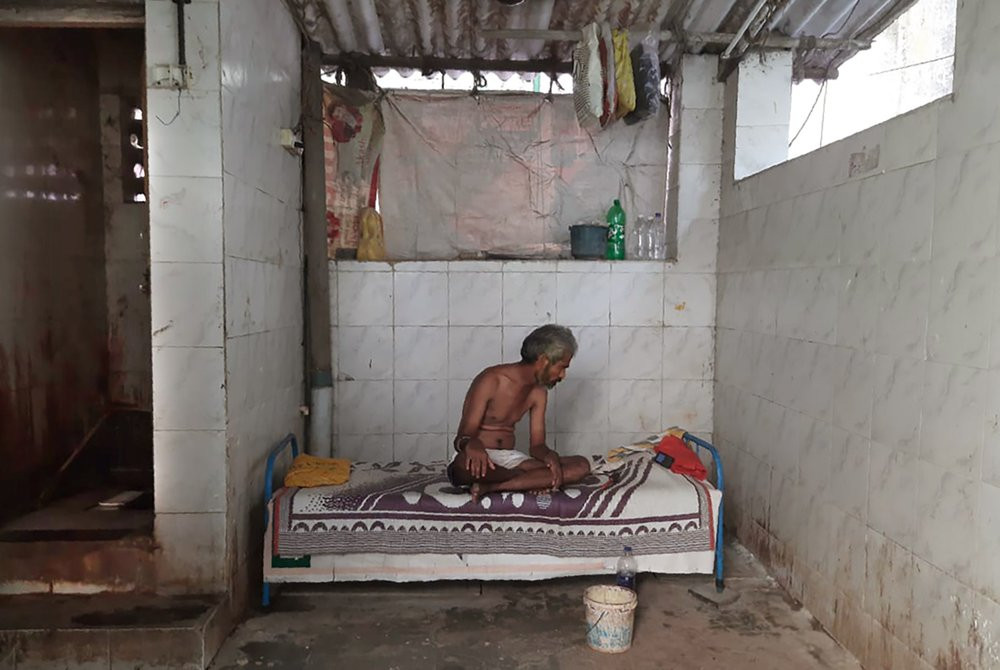 Raja Kadam rests on his bed inside a toilet complex in Dharavi, one of Asia's largest slums, in Mumbai, India, Saturday, May 16, 2020.