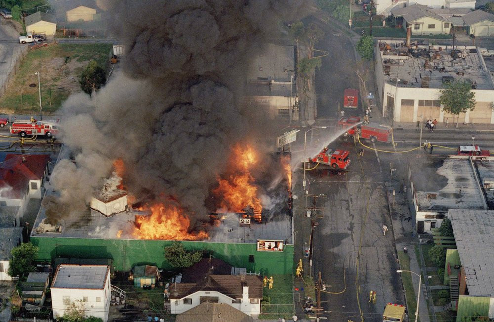 In this April 30, 1992 file photo, a fire burns out of control at the corner of 67th Street and West Boulevard in South Central Los Angeles. On April 29, 1992, four white police officers were