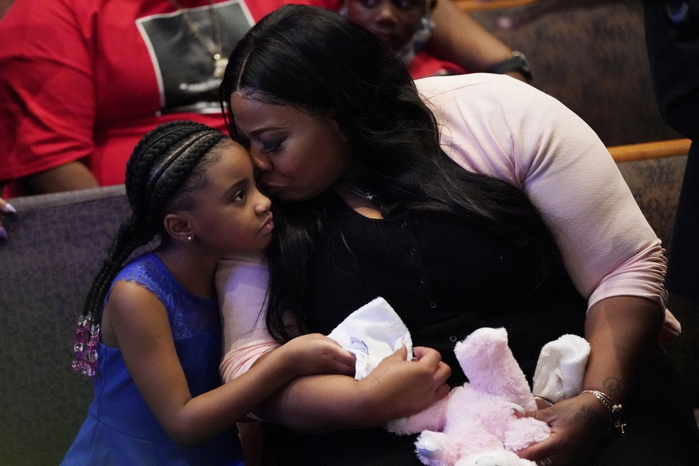 Roxie Washington holds Gianna Floyd, the daughter of George Floyd as they attend the funeral service for George Floyd at The Fountain of Praise church Tuesday, June 9, 2020, in Houston.
