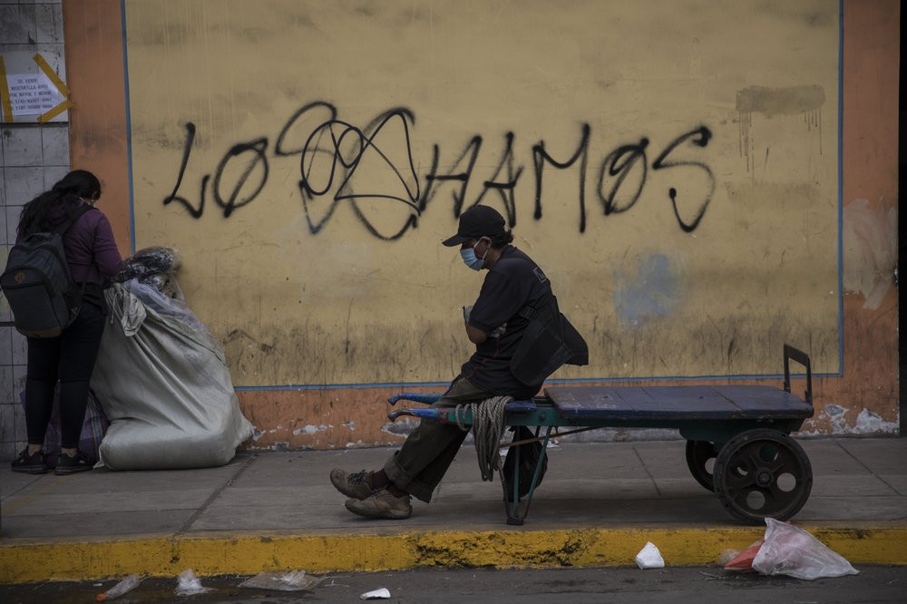A porter rests on his cart amid the new coronavirus pandemic, in La Victoria district of Lima, Peru, Friday, June 19, 2020.