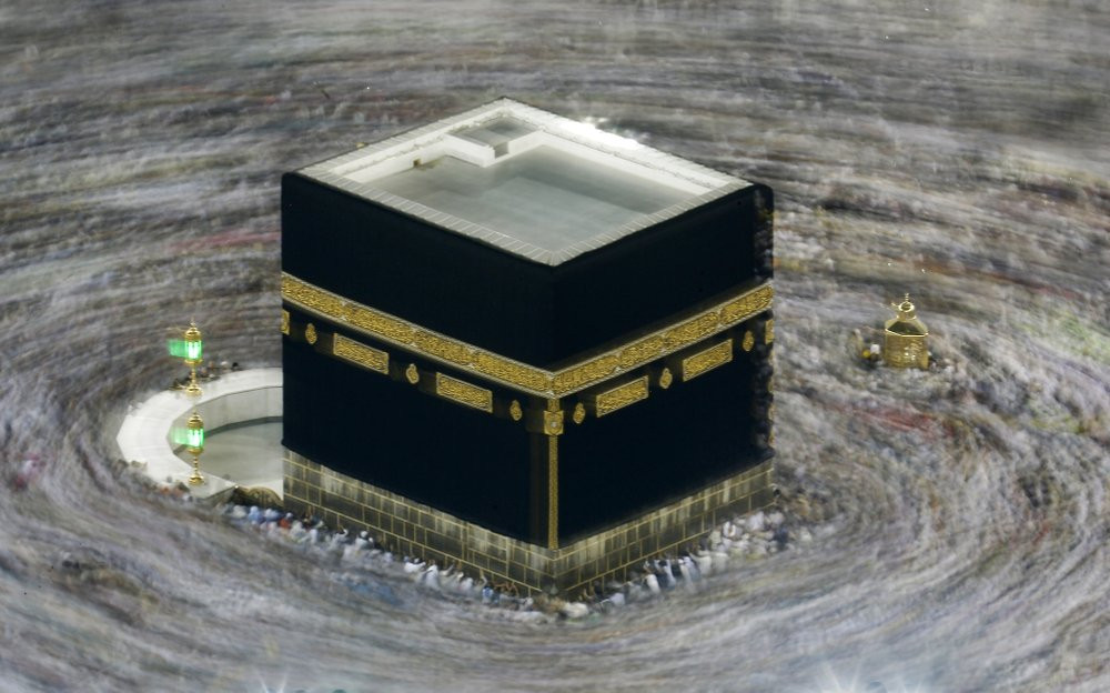 In this Aug. 13, 2019 file photo taken with slow shutter speed, Muslim pilgrims circumambulate the Kaaba, the cubic building at the Grand Mosque, durning the hajj pilgrimage in the Muslim hol