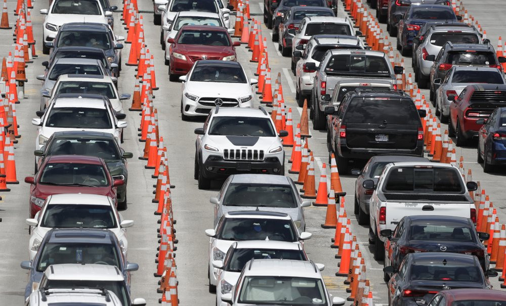 Lines of cars wait at a coronavirus testing site outside of Hard Rock Stadium, Friday, June 26, 2020, in Miami Gardens, Florida.
