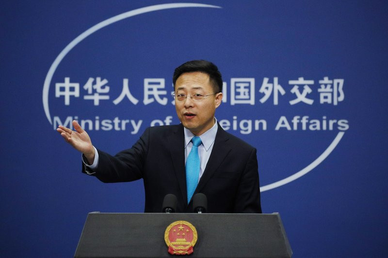 FILE - In this Feb. 24, 2020, file photo, Chinese Foreign Ministry spokesman Zhao Lijian gestures as he speaks during a daily briefing at his ministry in Beijing.