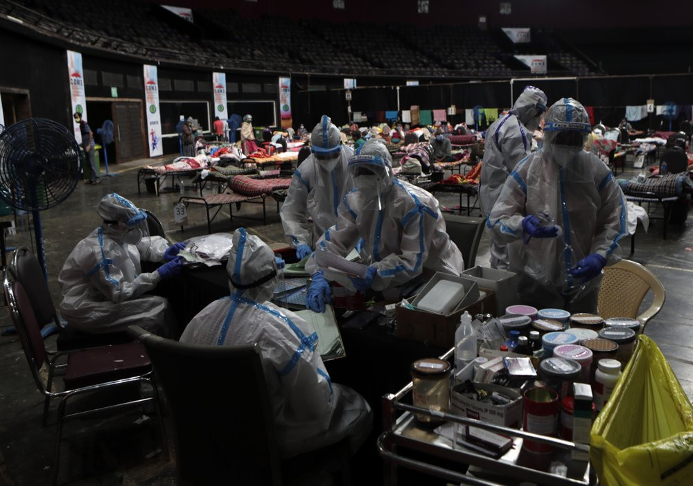 In this Wednesday, July 8, 2020, file photo, doctors and nurses work at a COVID-19 isolation center in Mumbai, India.