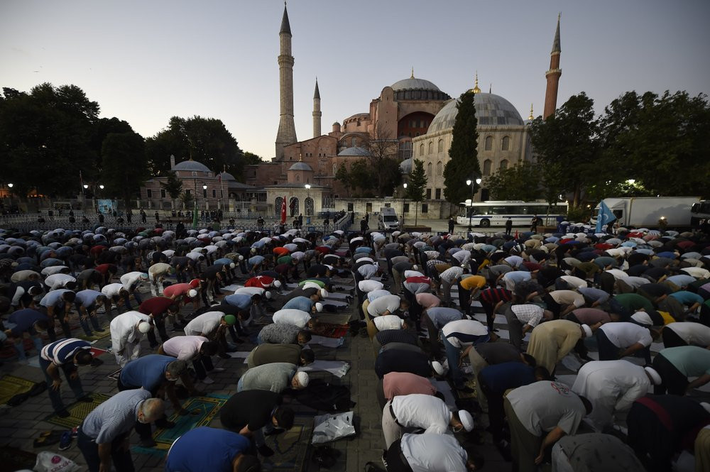 Muslims offer their evening prayers outside the Byzantine-era Hagia Sophia, one of Istanbul's main tourist attractions in the historic Sultanahmet district of Istanbul, following Turkey's Cou
